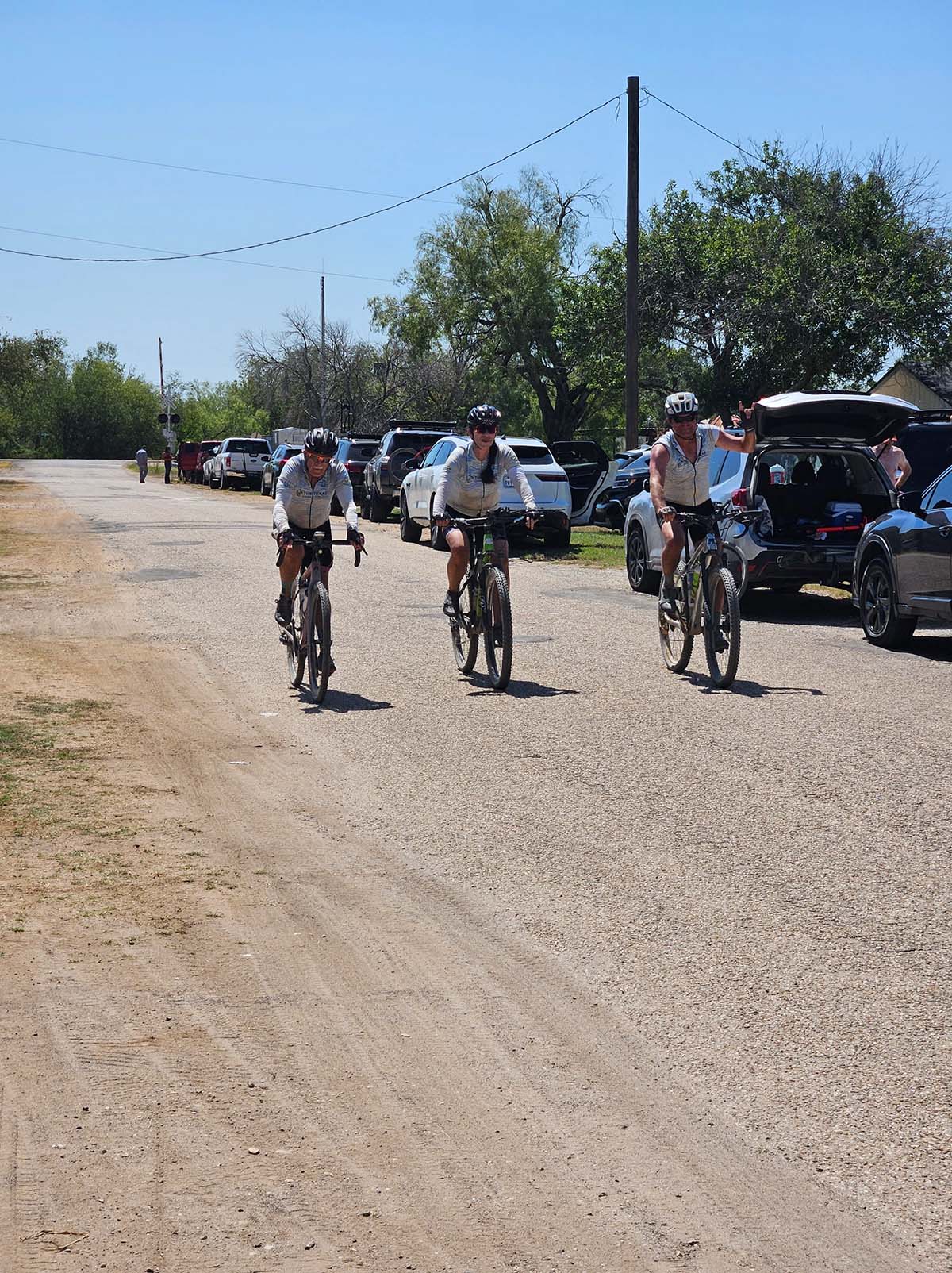 Group of three charity ride participants on their bikes